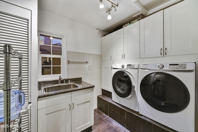 4610 N 14th Ave, Phoenix, AZ 85013 - laundry room with cabinet space, washer and dryer, tile walls, and dark tile patterned floors