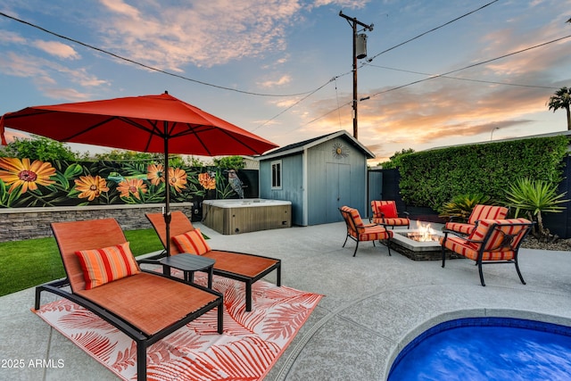 4610 N 14th Ave, Phoenix, AZ 85013 - patio terrace at dusk with a hot tub, an outdoor fire pit, a storage shed, a patio area, and a swimming pool