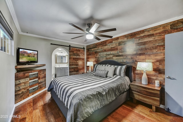4610 N 14th Ave, Phoenix, AZ 85013 - bedroom featuring wood walls, a barn door, crown molding, wood finished floors, and a ceiling fan
