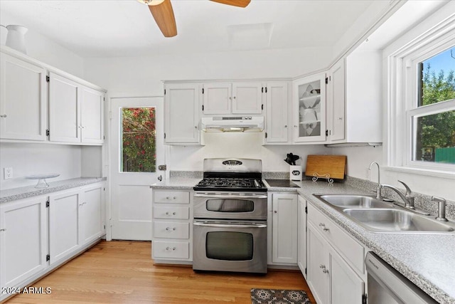 kitchen with white cabinets, appliances with stainless steel finishes, ceiling fan, and light hardwood / wood-style floors