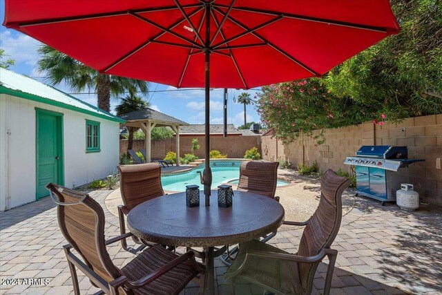 view of swimming pool featuring a patio, a gazebo, and an in ground hot tub