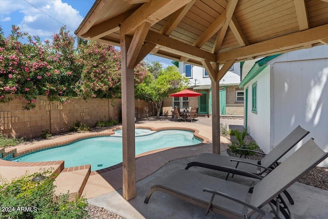 view of pool with a gazebo, a patio, a fenced backyard, and a pool with connected hot tub