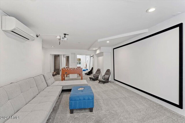 home theater room featuring a wall unit AC and light carpet