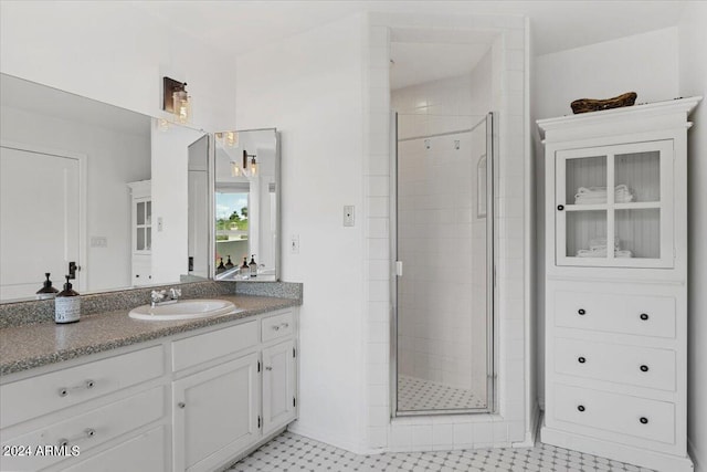 bathroom featuring vanity and a shower with shower door