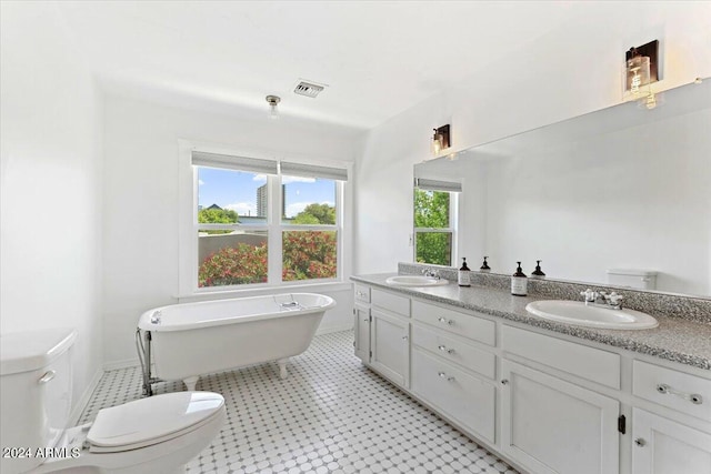 full bathroom with a sink, visible vents, toilet, and a soaking tub