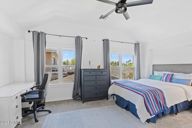 carpeted bedroom featuring visible vents, a ceiling fan, and lofted ceiling