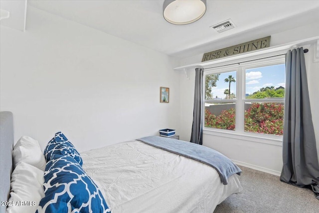 bedroom featuring visible vents, carpet flooring, and baseboards