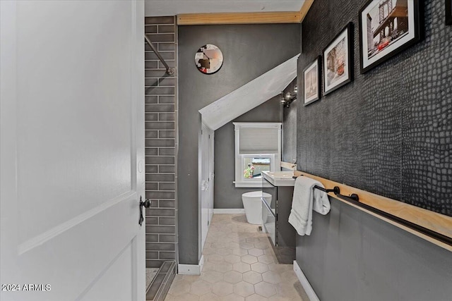 bathroom featuring vanity, baseboards, tile patterned flooring, an accent wall, and toilet