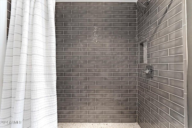 full bath with a tile shower