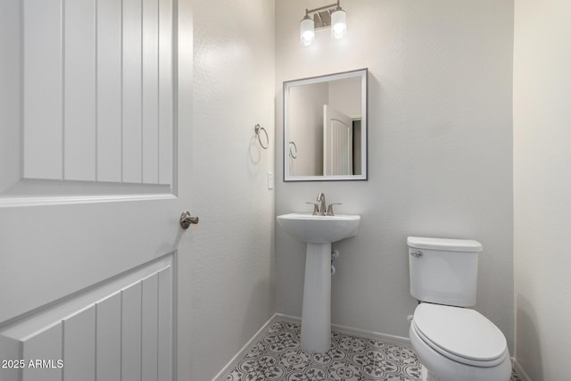 bathroom with tile patterned flooring, sink, and toilet