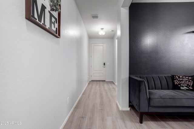 corridor with light hardwood / wood-style floors