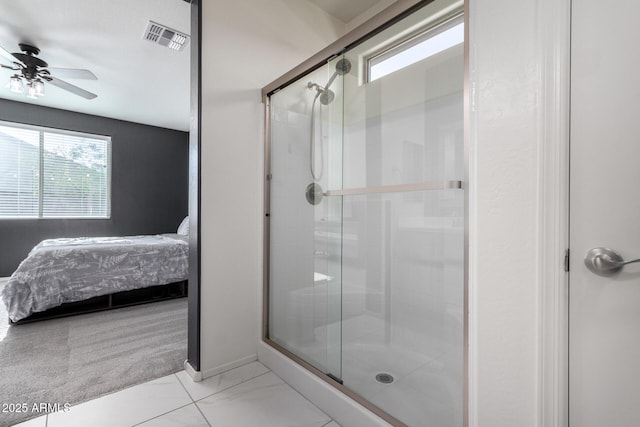 bathroom with an enclosed shower and ceiling fan