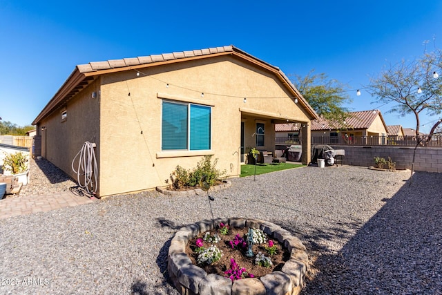 back of property with a patio