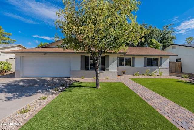 ranch-style house featuring a garage and a front lawn