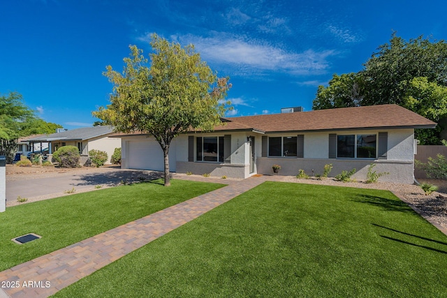 single story home featuring a garage and a front yard