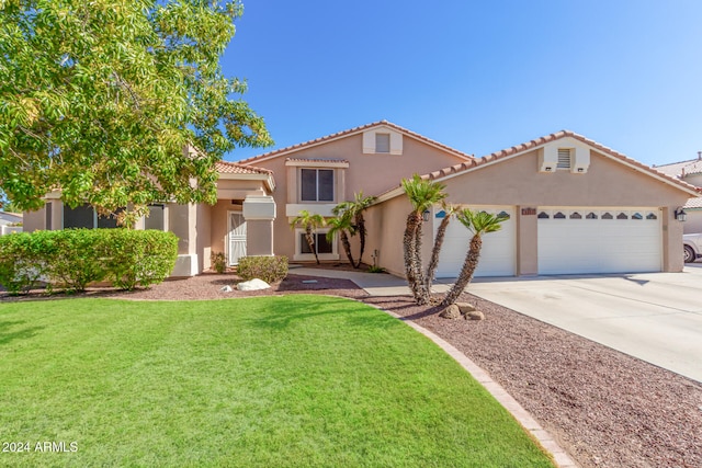 mediterranean / spanish-style house with a garage and a front yard