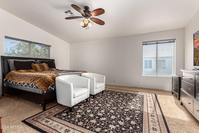 bedroom with light colored carpet, multiple windows, ceiling fan, and vaulted ceiling