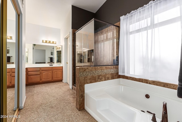 bathroom featuring vanity and separate shower and tub