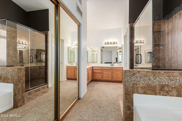 bathroom featuring vanity, plus walk in shower, and tile walls