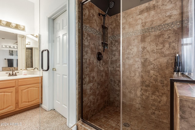 bathroom featuring vanity and an enclosed shower