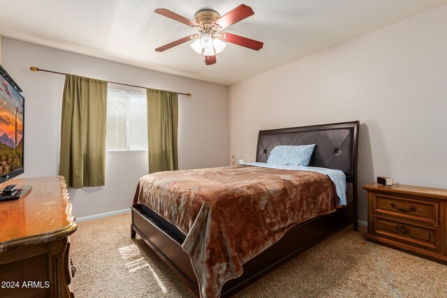 bedroom with light carpet and ceiling fan