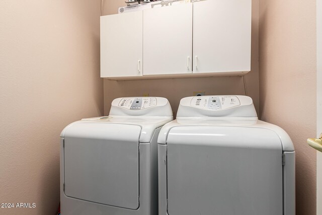 laundry room with cabinets and washer and dryer