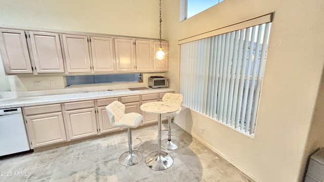 11854 E Carol Ave, Scottsdale, AZ 85259 - kitchen with a high ceiling, dishwasher, pendant lighting, concrete flooring, and tile counters