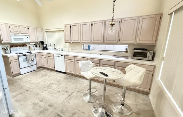 11854 E Carol Ave, Scottsdale, AZ 85259 - kitchen featuring white appliances, a high ceiling, decorative light fixtures, and a ceiling fan