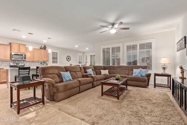 living room with ceiling fan and light tile patterned flooring