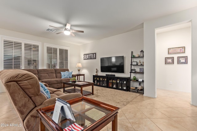 living room featuring light tile patterned floors and ceiling fan