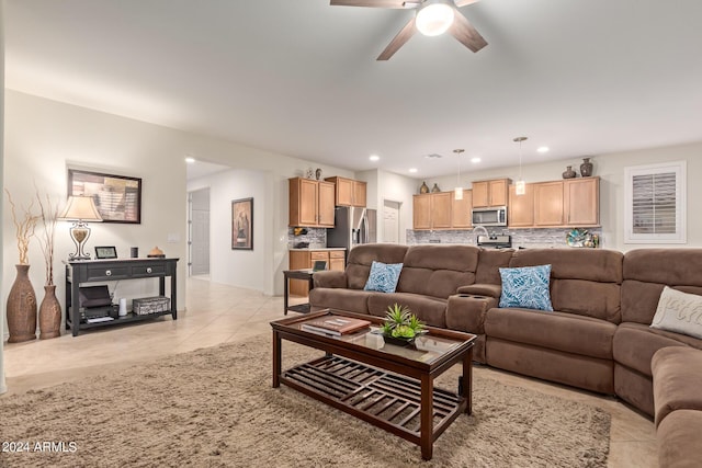 tiled living room with ceiling fan