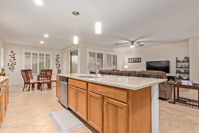 kitchen featuring sink, light stone counters, a center island with sink, stainless steel dishwasher, and pendant lighting