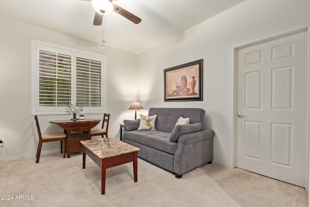 carpeted living room with ceiling fan