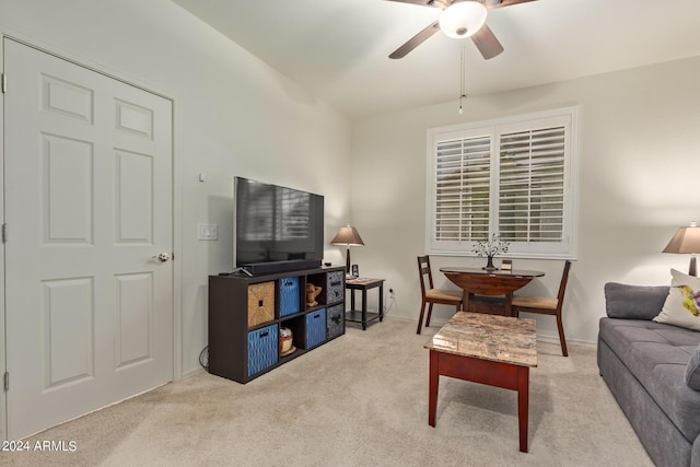 carpeted living room with ceiling fan