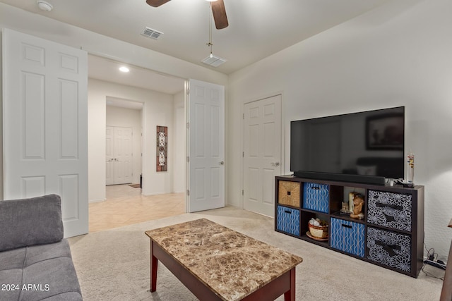 carpeted living room with ceiling fan