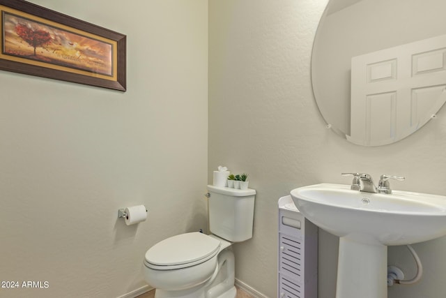 bathroom featuring toilet and sink