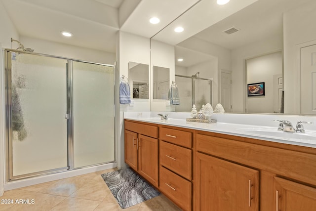 bathroom with tile patterned flooring, an enclosed shower, and vanity