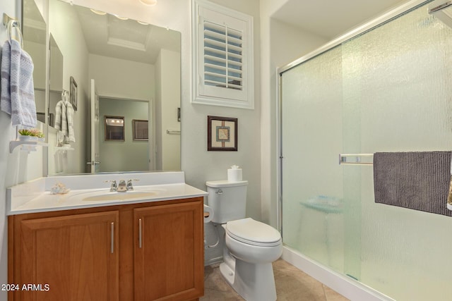 bathroom featuring tile patterned floors, toilet, an enclosed shower, and vanity