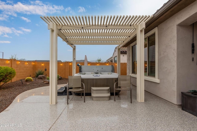 view of patio / terrace featuring a hot tub and a pergola