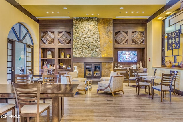 interior space featuring built in shelves, a fireplace, and light hardwood / wood-style floors