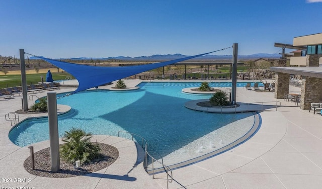 view of pool featuring a mountain view and a patio area