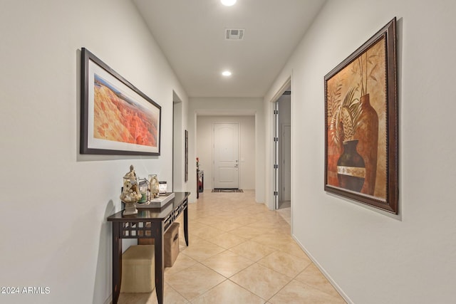 hall featuring light tile patterned floors