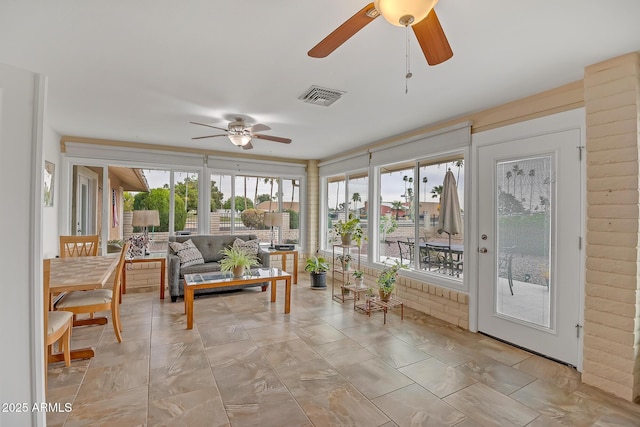 sunroom / solarium featuring visible vents and a healthy amount of sunlight