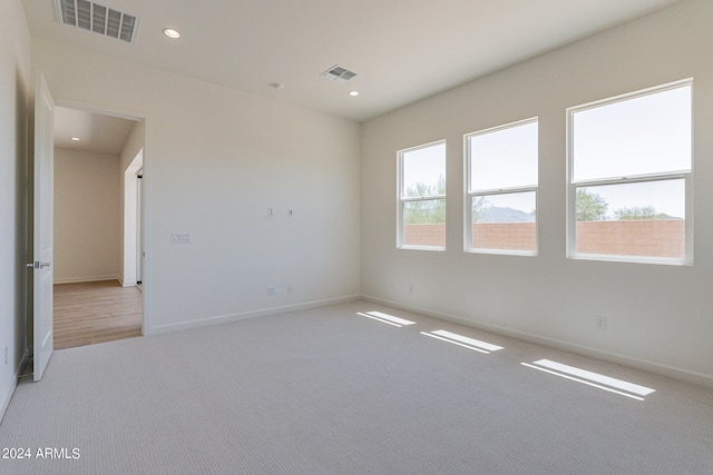 empty room featuring light colored carpet