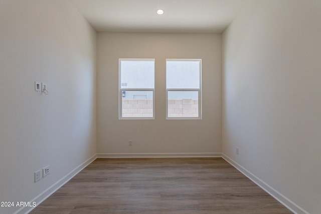 unfurnished room with hardwood / wood-style flooring