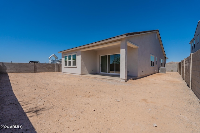 back of house featuring central AC unit and a patio area