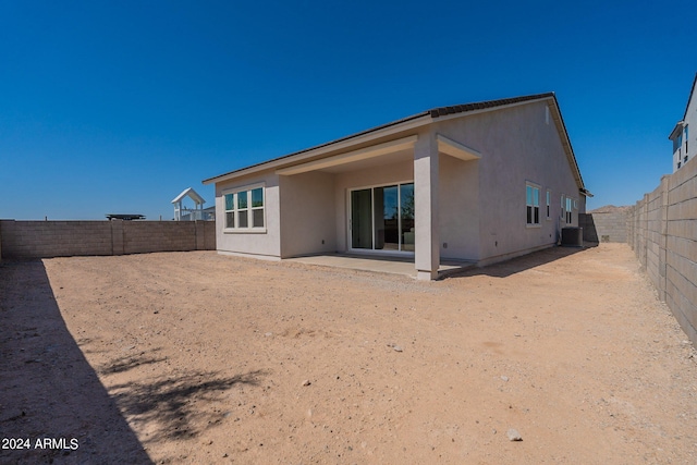 rear view of property featuring a patio and central air condition unit