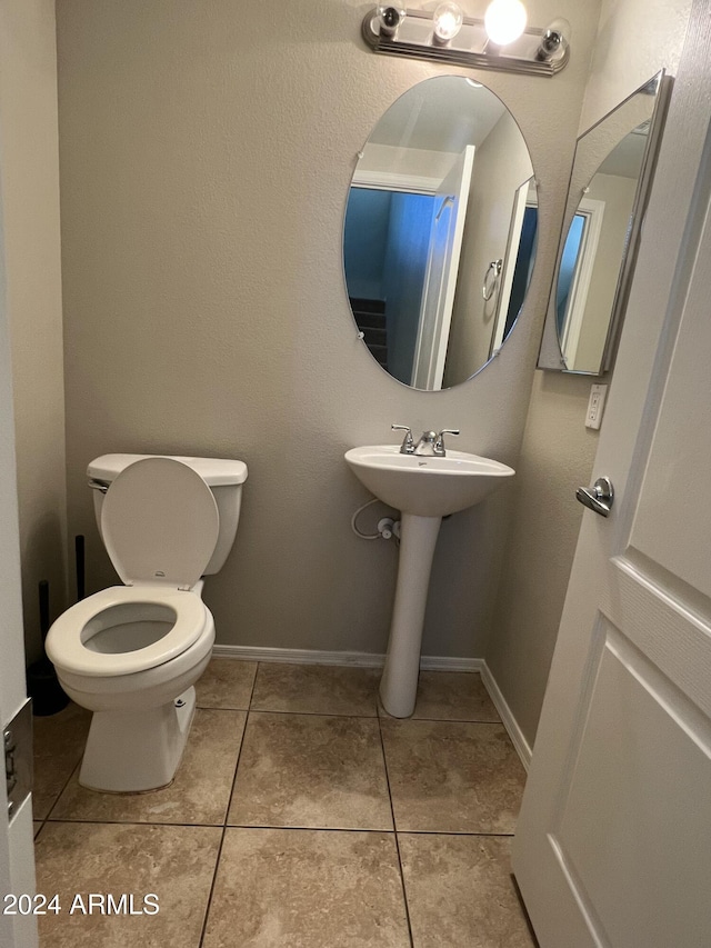 bathroom with tile patterned floors, toilet, and sink