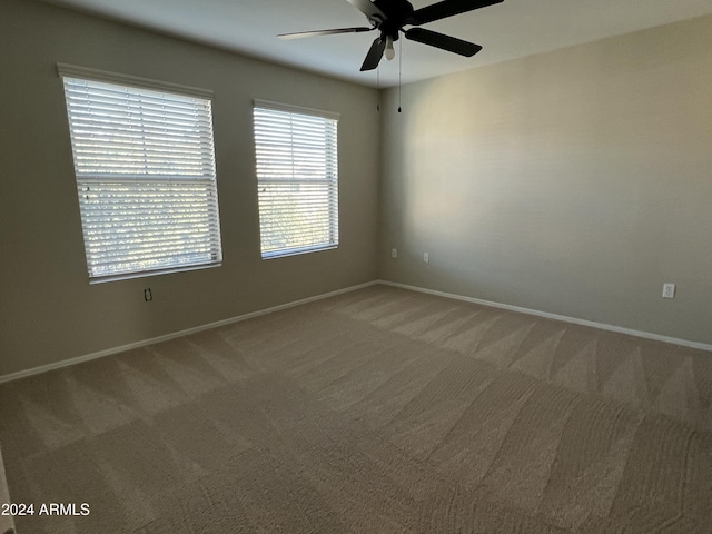 empty room with carpet floors and ceiling fan