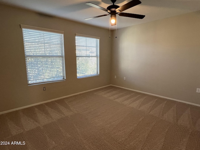 spare room with carpet and ceiling fan